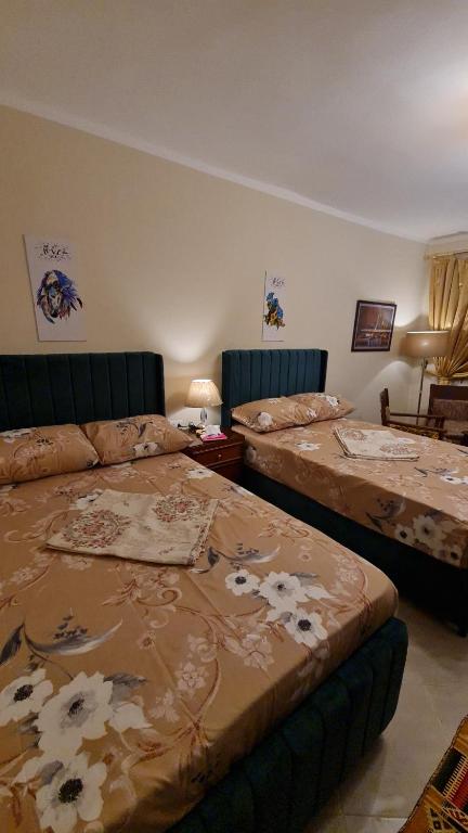 a room with two beds and a room with at استوديو فندقي مكيف وفيو رائع in Borg El Arab