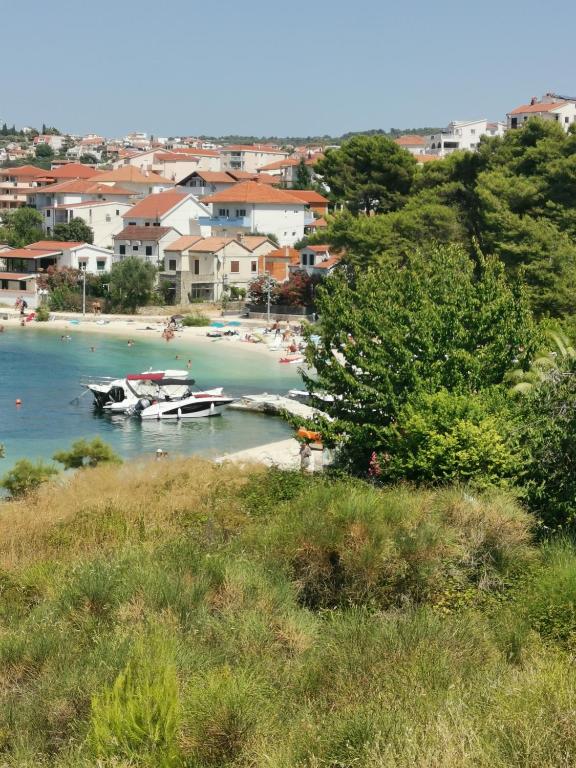 un barco está atracado en una playa con casas en Apartment Croatika on the Beach, en Trogir