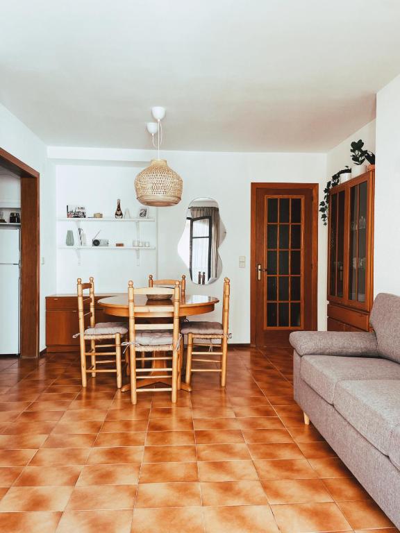 a living room with a table and chairs and a couch at Cal Morenet in Palamós