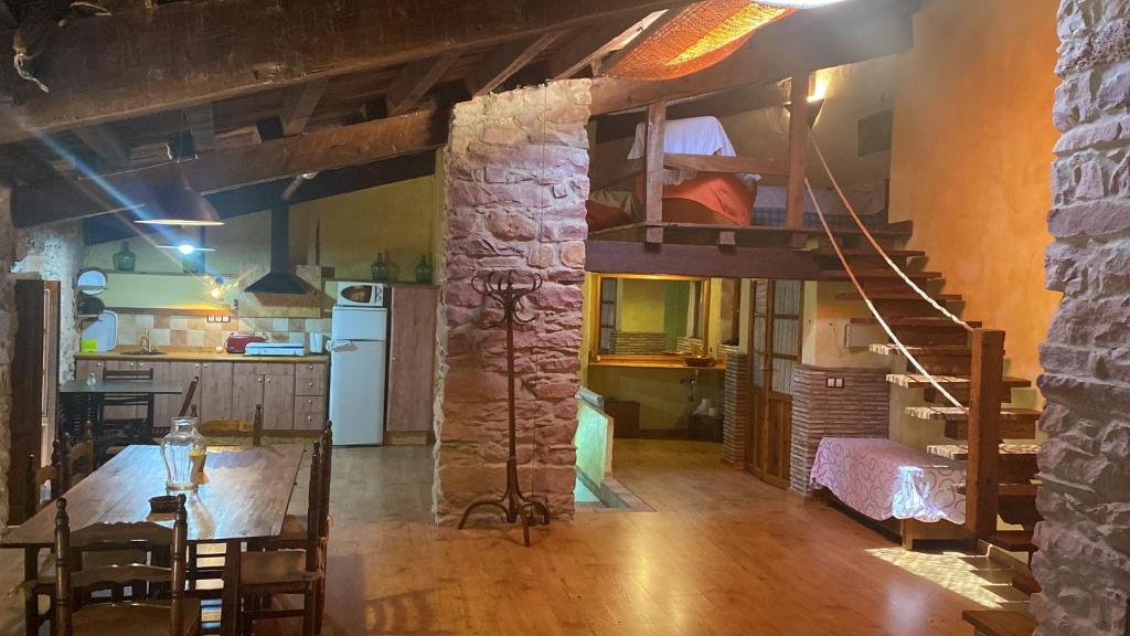 a living room with a loft bed and a kitchen at Casa Pastor in Villafamés