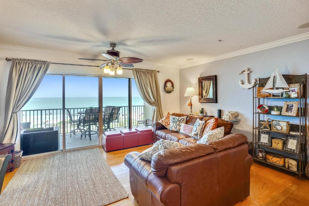 a living room with a couch and a view of the ocean at Oceanside 302 in Clearwater Beach
