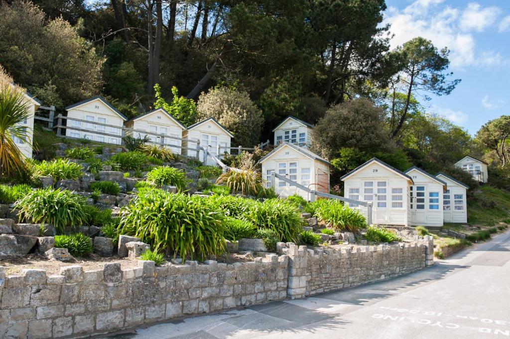 a row of houses next to a stone wall at The Canford in Poole