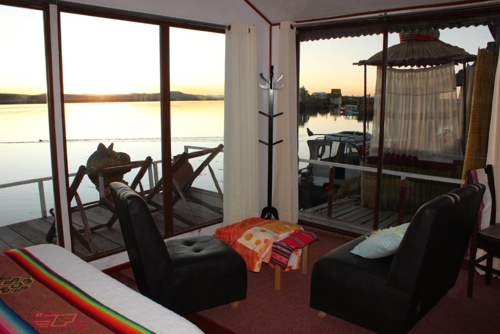 a screened in porch with a view of the water at Titicaca Aruntawi Lodge Peru in Puno