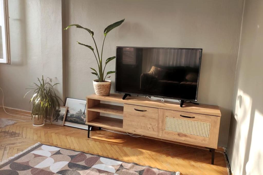 a flat screen tv sitting on top of a wooden entertainment center at Our flat is located in Beşiktaş Square. in Istanbul