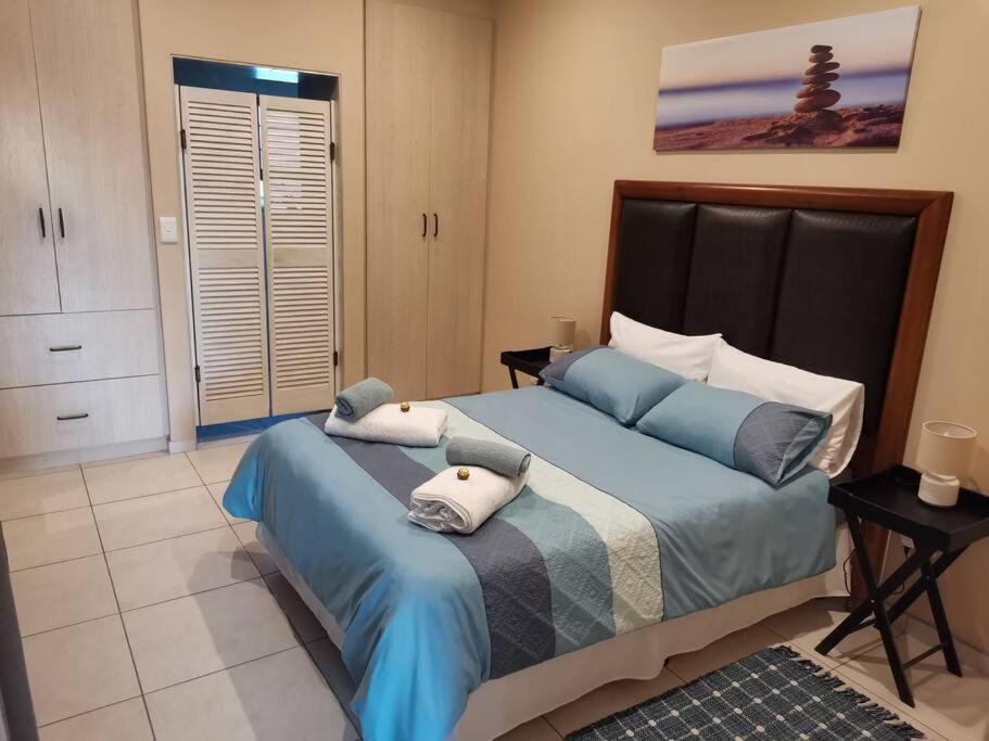 a bedroom with a large bed with two pillows on it at Desert Pearl Self catering & Accommodation in Walvis Bay