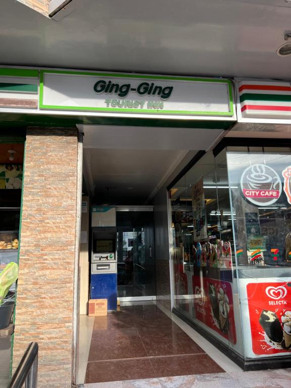 un frente de tienda con un signo de chip dmg en él en Ging-Ging Tourist Inn, en Badian