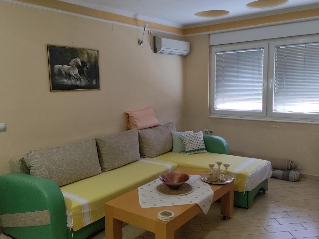 a living room with a couch and a table at Central apartment in Gevgelija