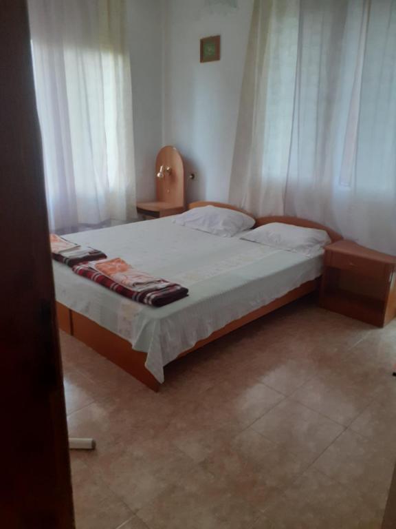 a bedroom with a large bed with white curtains at Варвара- Ятрус in Varvara