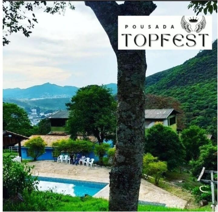 a sign for a resort with a swimming pool at PousadaTopFest in Poços de Caldas