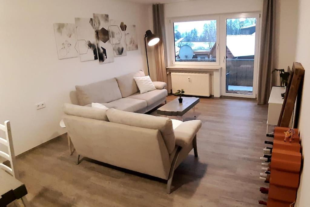 a living room with a couch and a table at Ferienwohnung zur dicken Berta in Wolfegg
