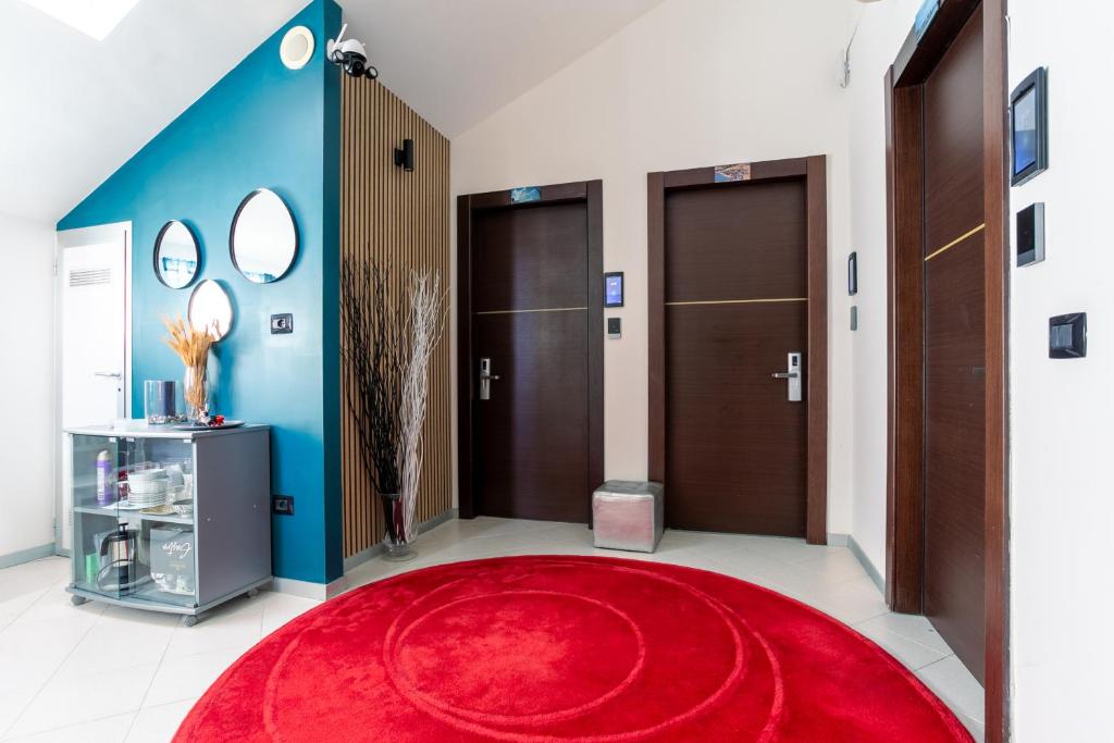 a hallway with two doors and a red rug at New Pescara City b&b in Pescara