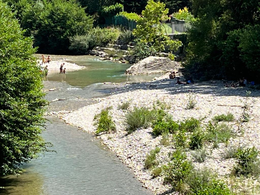 a group of people on a beach next to a river at Sur le Pont in Vaison-la-Romaine
