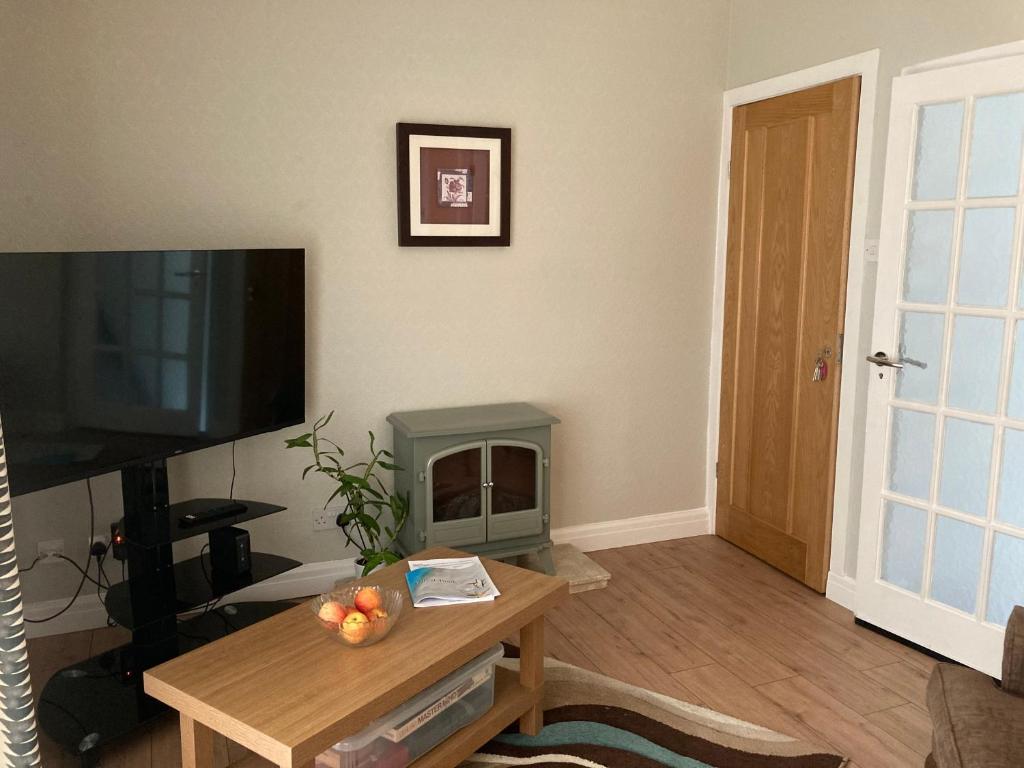 a living room with a fireplace and a television at Quiet flat with parking in Cleveleys