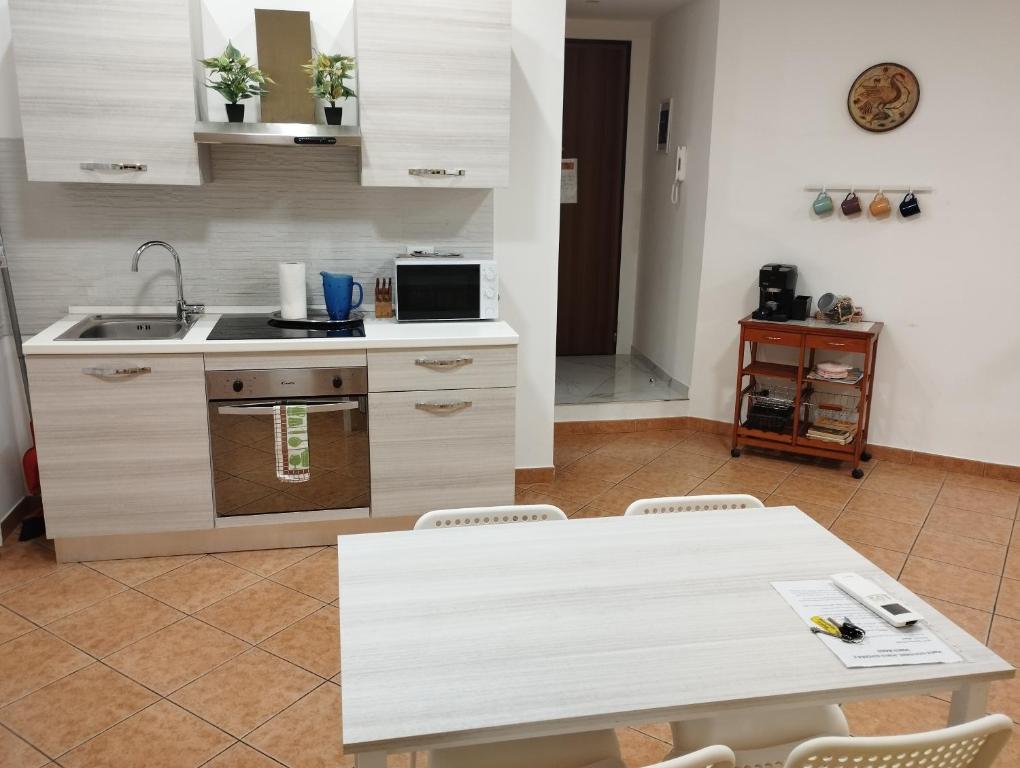 a kitchen with a white table and a sink at Domus Genuensis in Genova