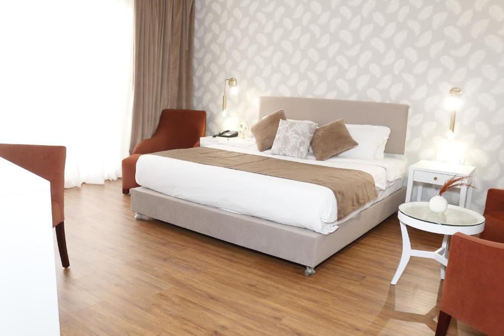 Postel nebo postele na pokoji v ubytování Tolip Family Park Hotel
