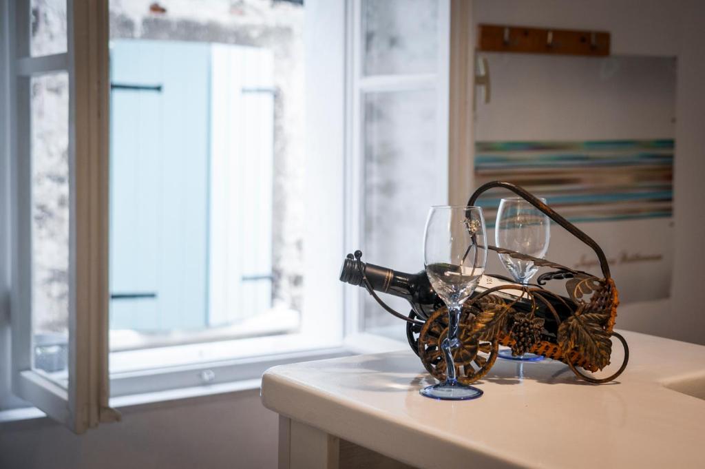 a wine glass sitting on a counter next to a window at Rovinj Romance Apartment in Rovinj