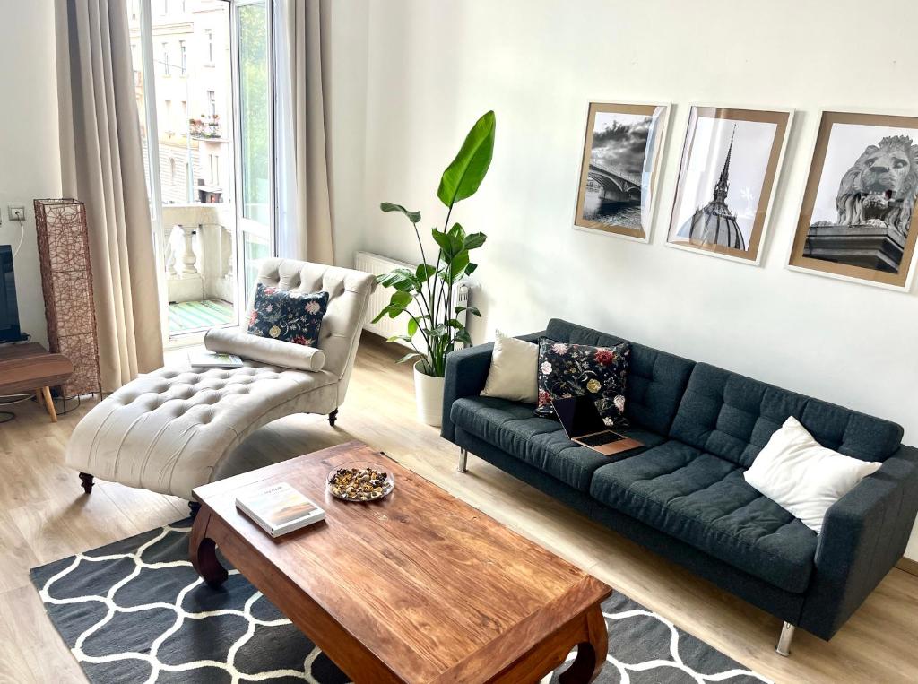 a living room with a couch and a coffee table at Danube Terrace Boutique Residence with private sauna in Budapest