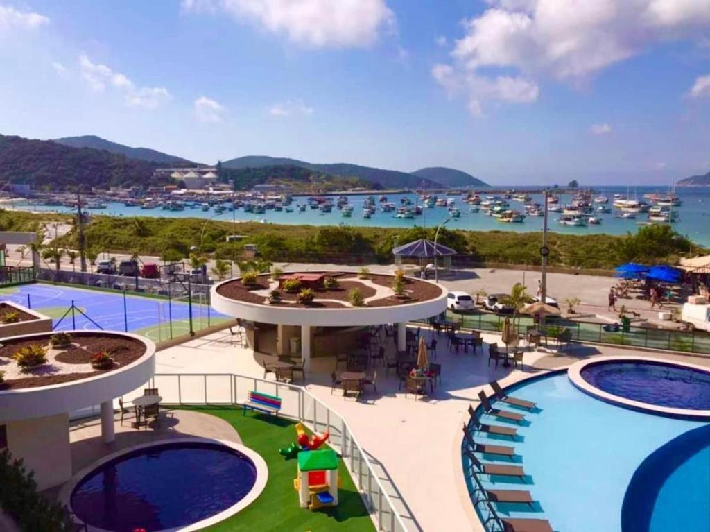 アハイアウ・ド・カボにあるPraia Dos Anjos Residence clubのマリーナ付きのリゾートのプールの景色を望めます。