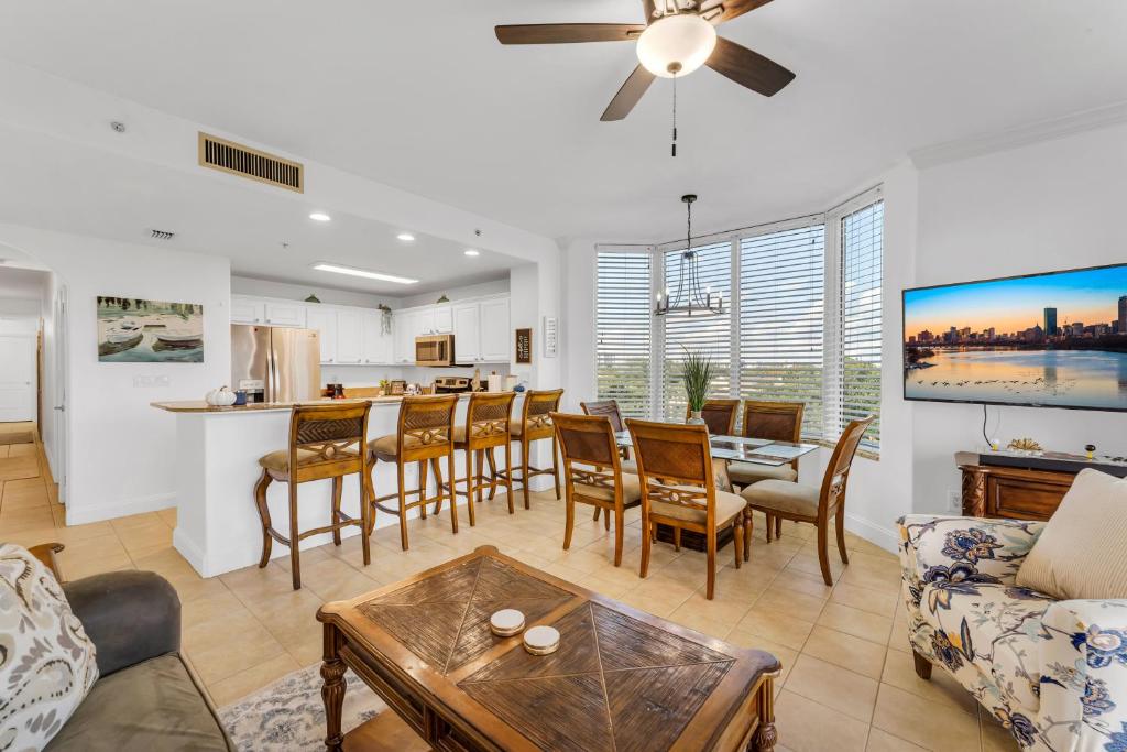 a living room with a kitchen and a dining room at 2BR condo minutes to Disney Springs in Orlando