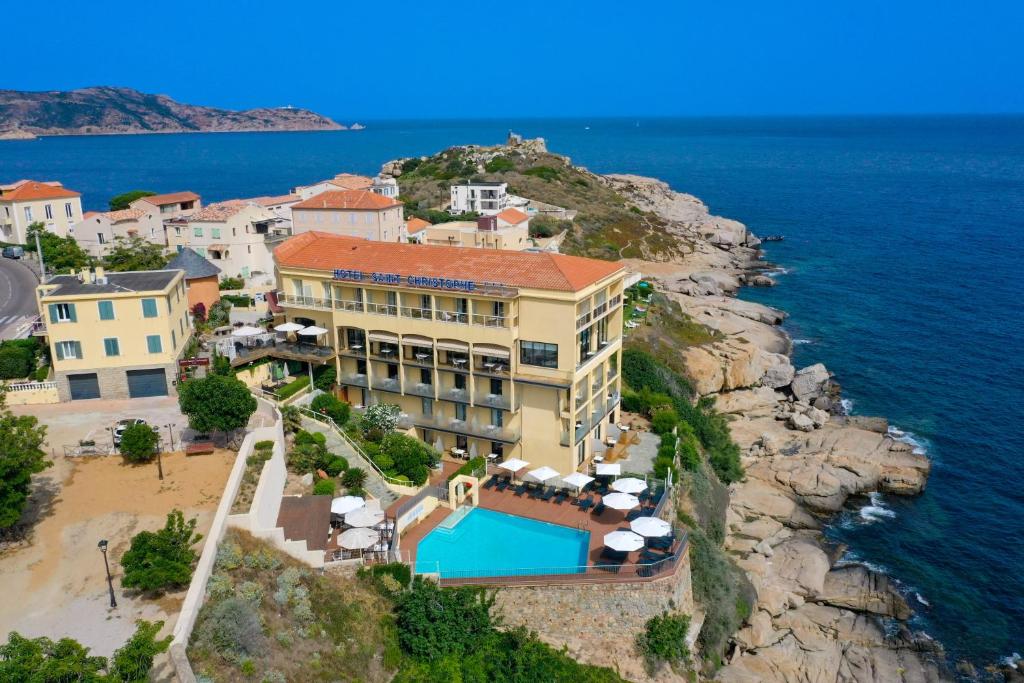 an aerial view of a hotel on a cliff with the ocean at Hotel Saint Christophe in Calvi