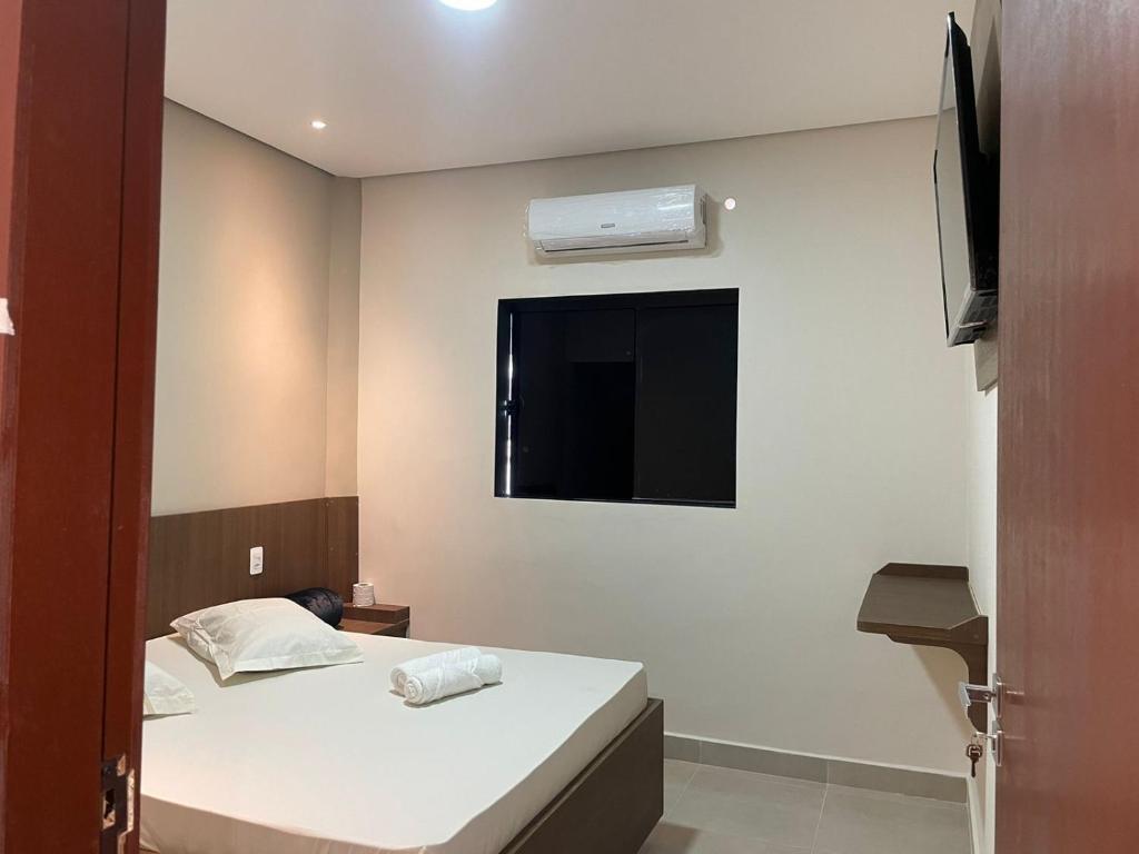 a small room with two beds and a television at Hotel Max Tatuapé in Sao Paulo