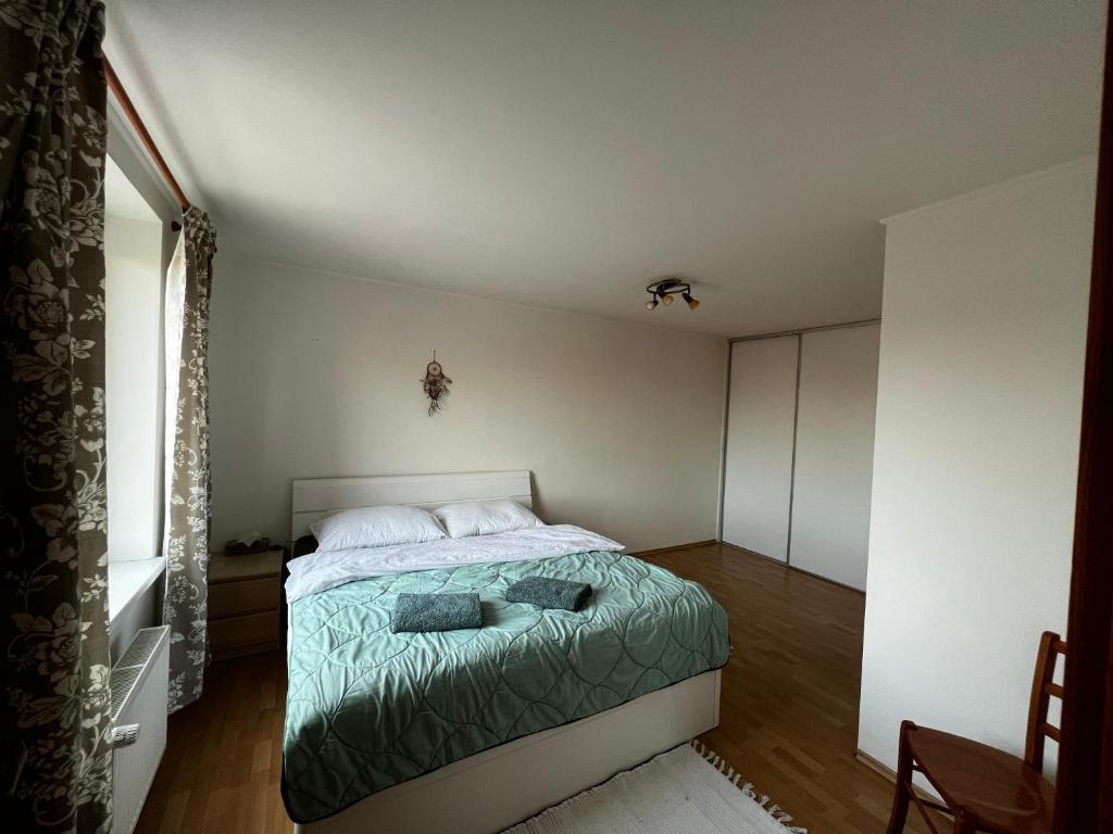 a bedroom with a bed and a large window at Apartmán MW in Poprad