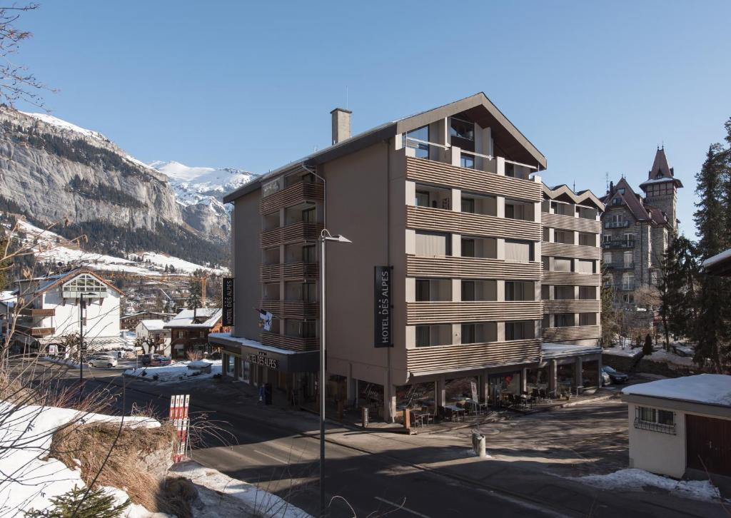 un edificio nel mezzo di una città con la neve di Hotel des Alpes a Flims