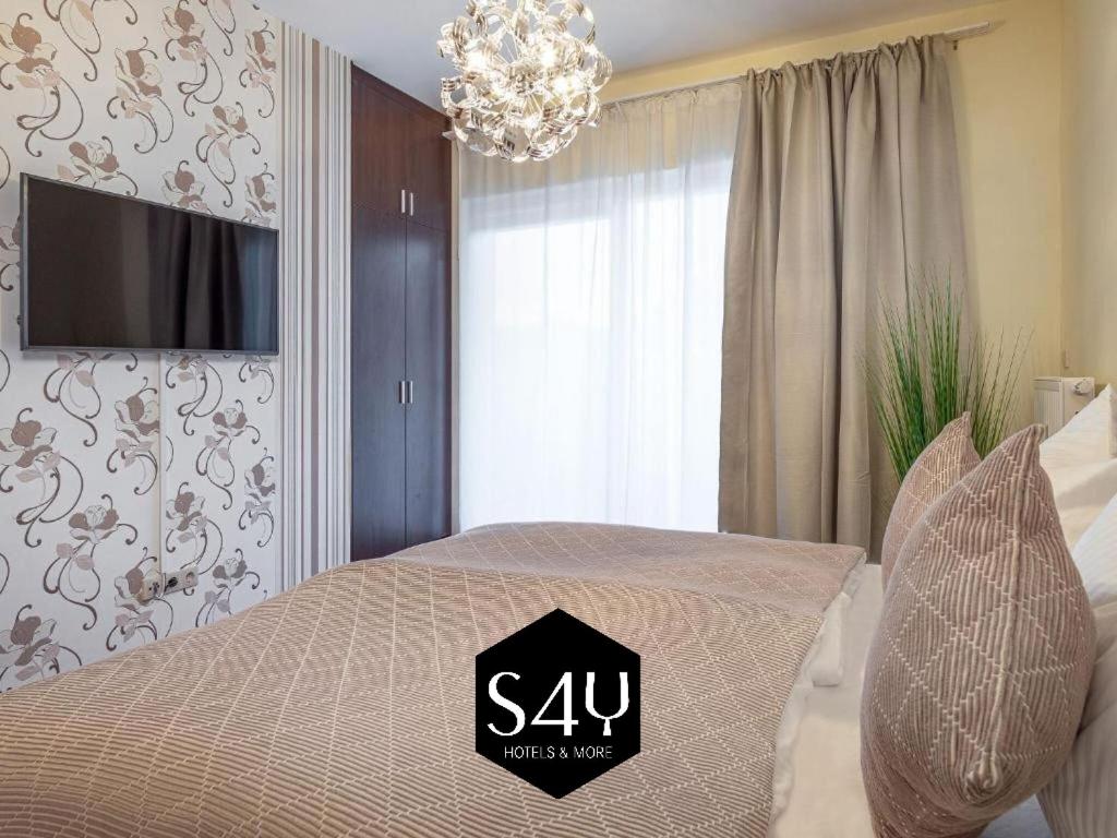 a bedroom with a bed with a sign on it at Alpe Adria Apartments - Top 1 by S4Y in Faak am See
