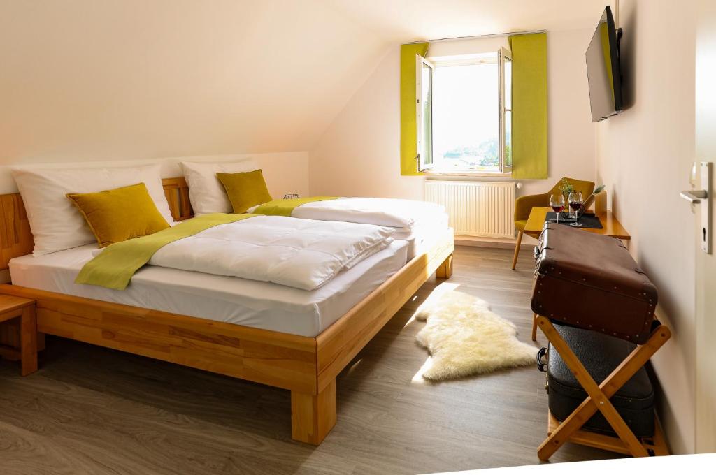 a bedroom with two beds and a television in it at Panoramablick Scheifling in Lind bei Scheifling