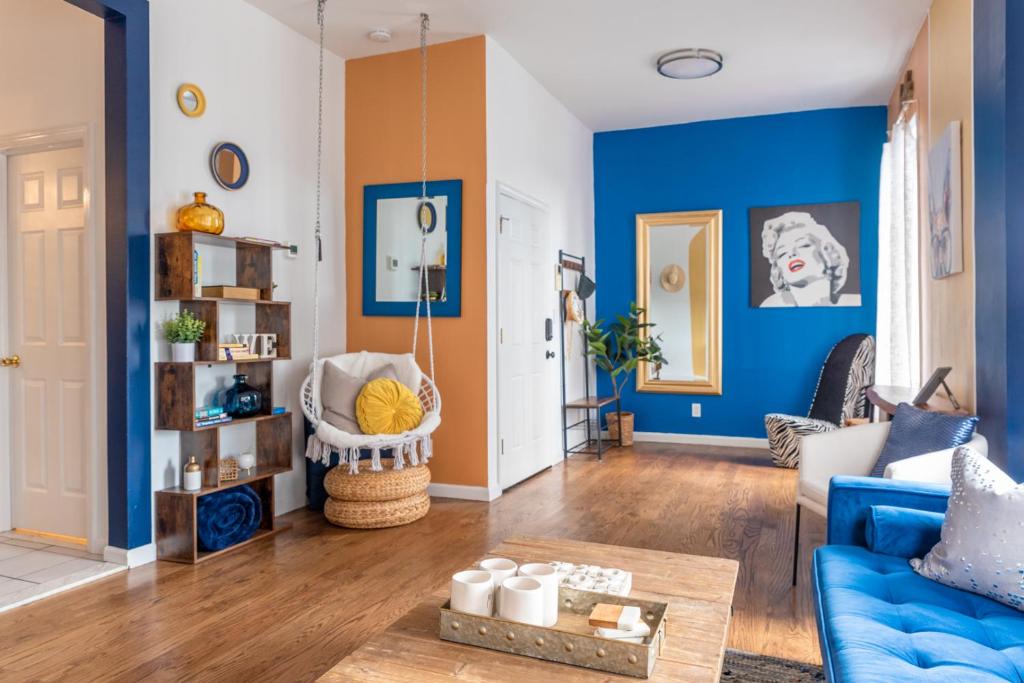 a living room with blue walls and a blue couch at Royal Glam-Marilyn inspired 1BD - 30 Min to NYC in Edgewater