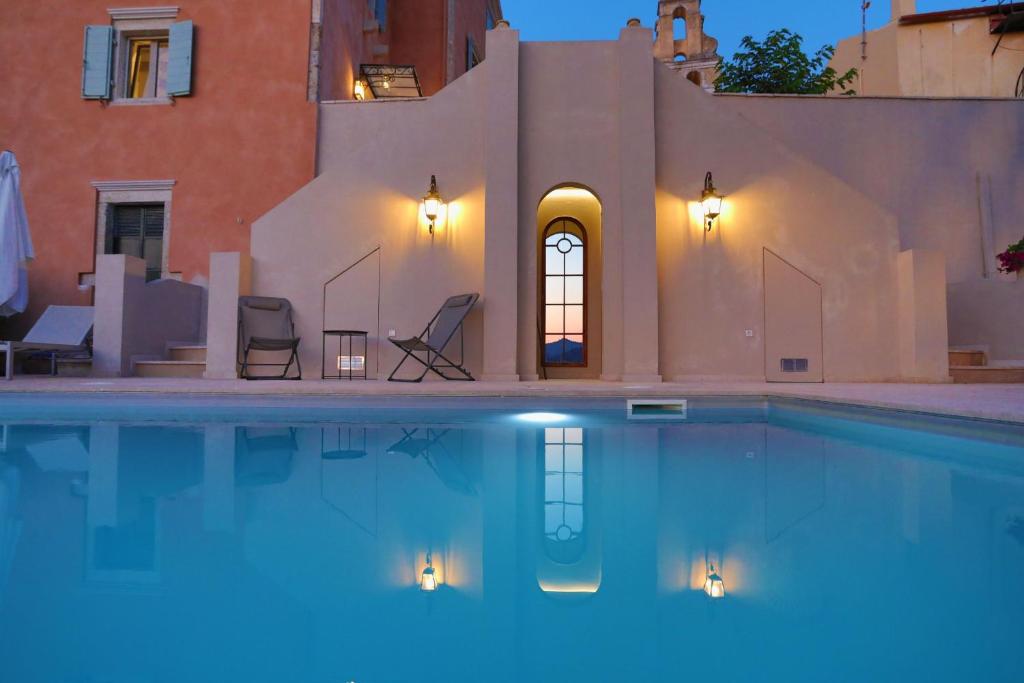 a swimming pool in front of a house at Achillion Casa Conti 1840 in Gastouri