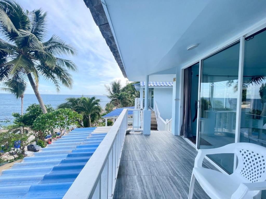 a balcony of a house with a view of the ocean at Naiharn On The Rock Resort Phuket in Nai Harn Beach
