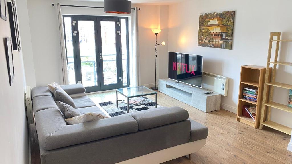 a living room with a couch and a television at City Centre Apartment Jewellery Quarter in Birmingham