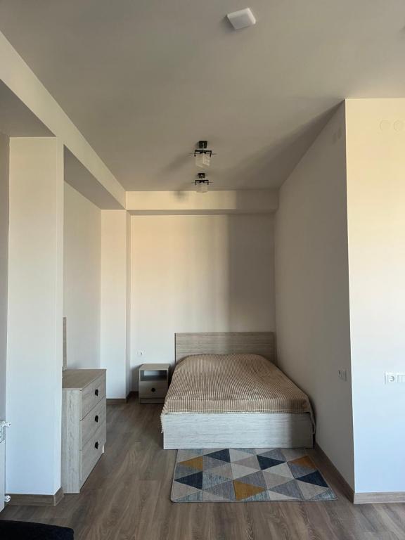 a bedroom with a bed in a room at Ines’s sweet home in Yerevan