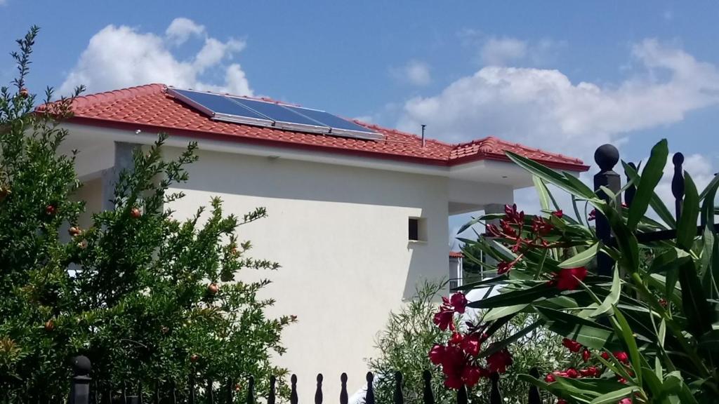 a house with a roof with solar panels on it at Kandis Place in Metamorfosi