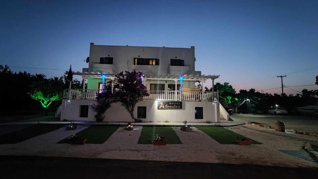 a large white building with a balcony in front of it at Afendra Hotel in Skiros