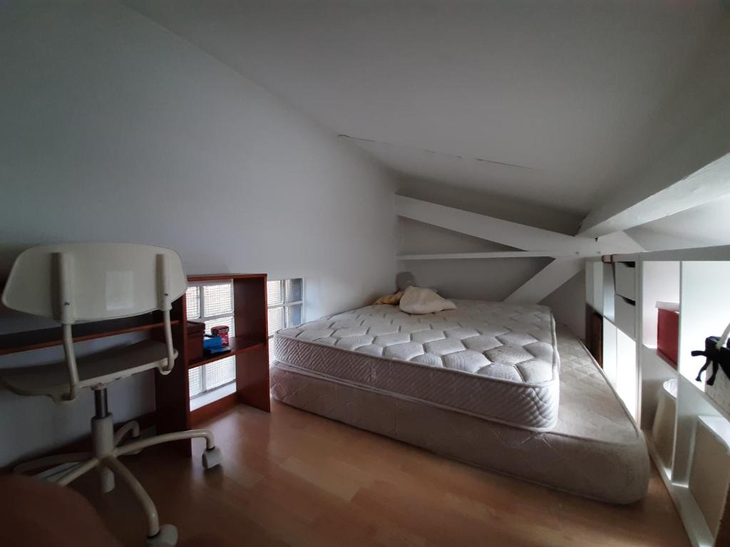 a bedroom with a bed and a desk and a chair at Loft en duplex 270 m2 &amp; Jardin patio terrasse sauna in Chaville