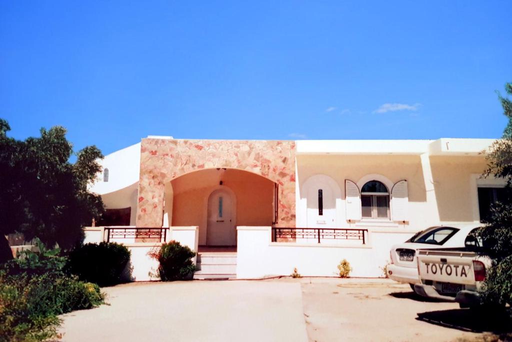 a house with a car parked in front of it at Ioanna's Villa 10 minutes walking from sea in Gra Liyiá