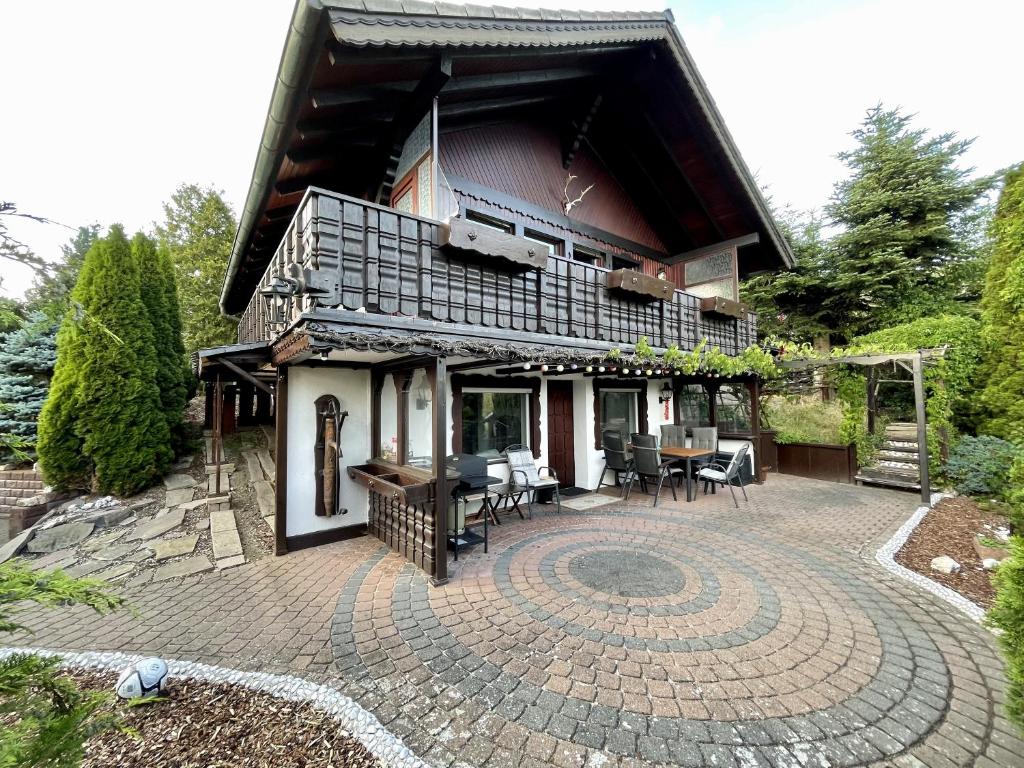 a large house with a patio and a building at Haus Balke in Hatzfeld