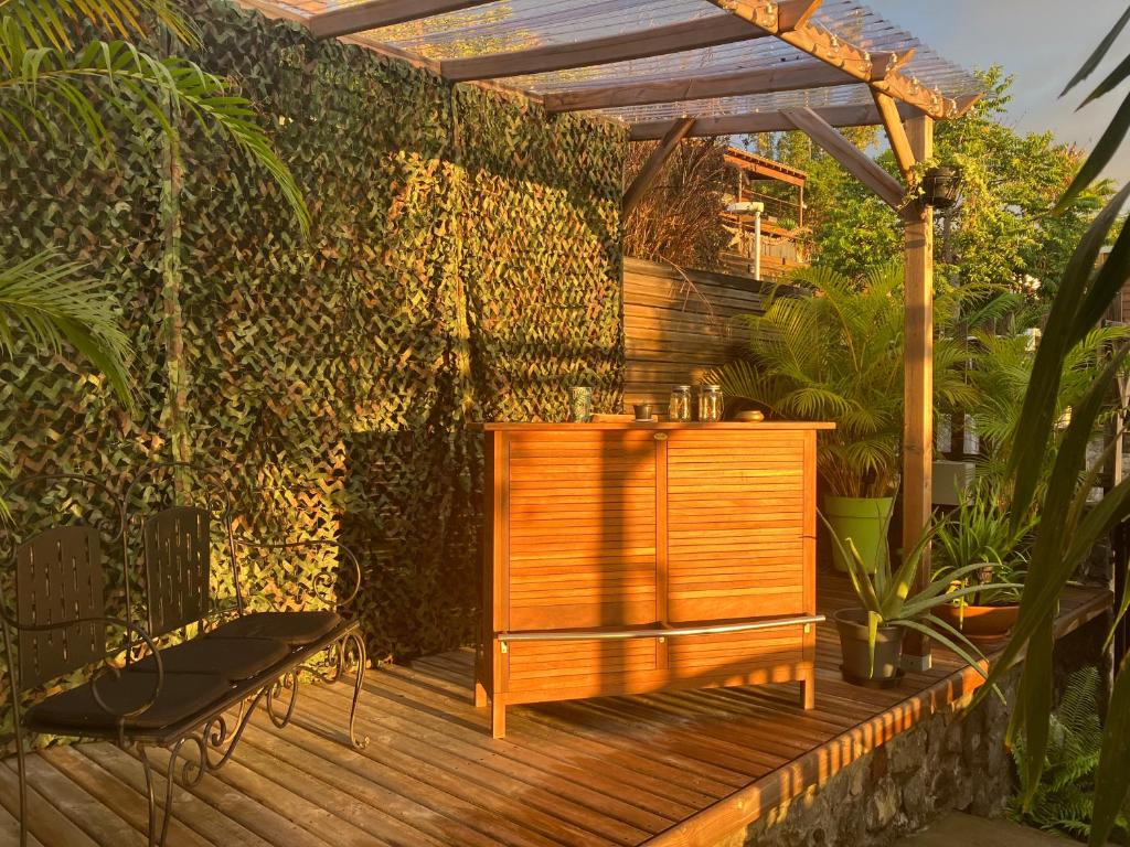 une terrasse en bois avec une table en bois et une clôture dans l&#39;établissement Chambre d&#39;hôtes Austral 180, à La Possession