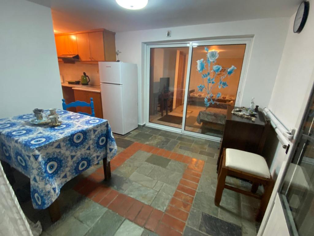 a small kitchen with a table and a refrigerator at Sea view apartament Psalidi in Kos Town