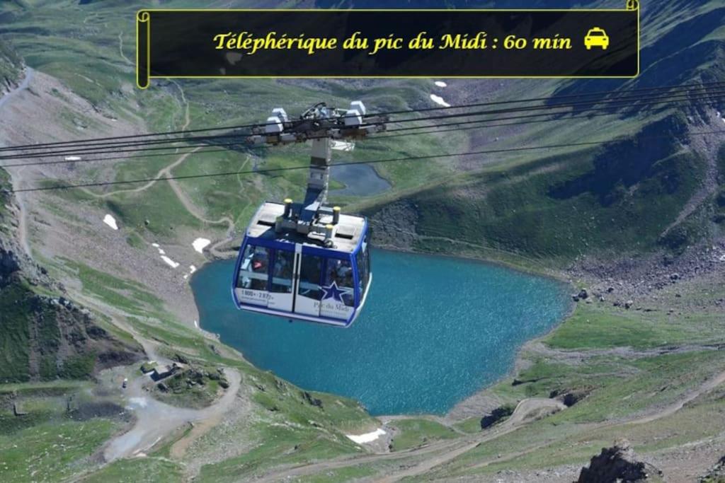 a blue and white helicopter flying over a lake at LE MEDITERRANEEN *T2 (40m²) *WIFI*PARKING PRIVE* in Lourdes
