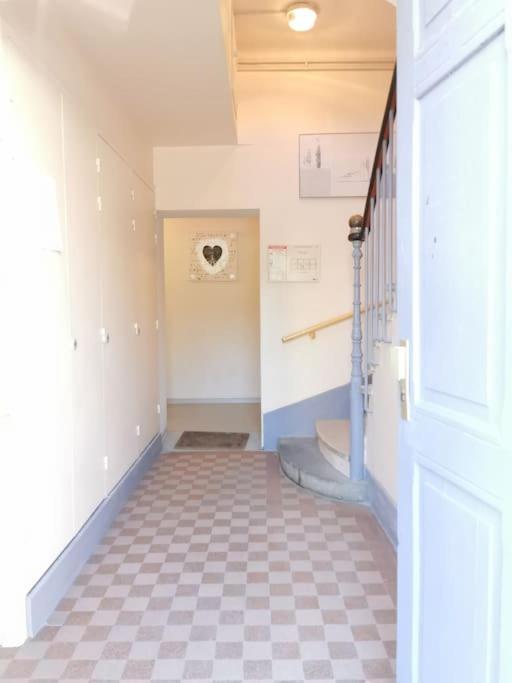 a hallway with a staircase and a tile floor at LE MEDITERRANEEN *T2 (40m²) *WIFI*PARKING PRIVE* in Lourdes
