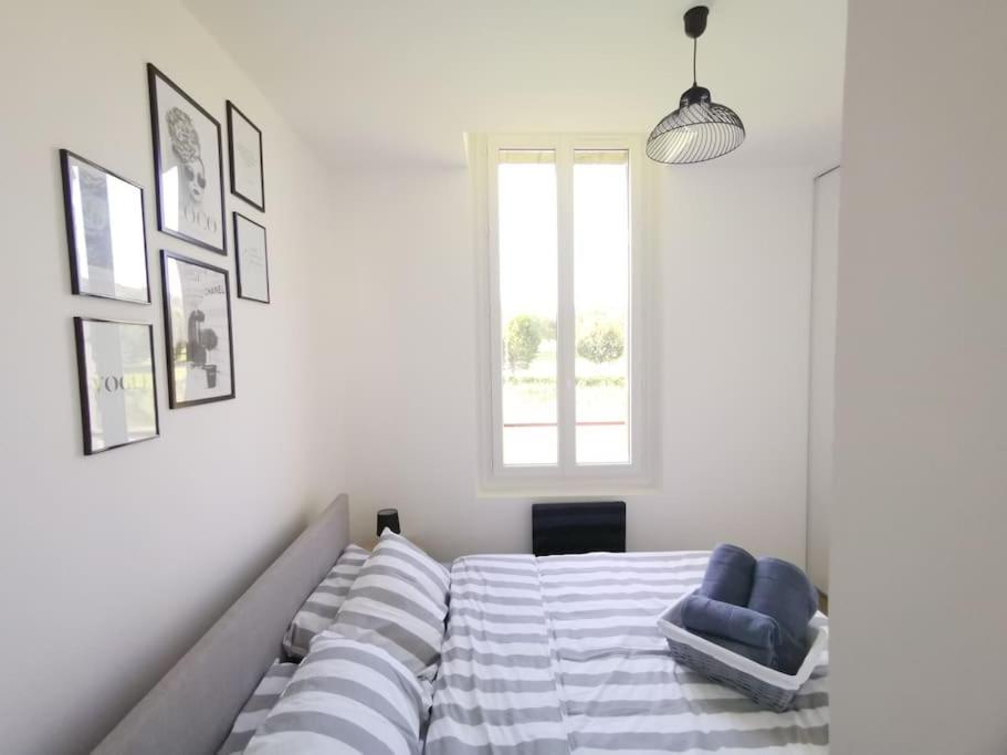 a bedroom with a bed and a blue chair at LE MEDITERRANEEN *T2 (40m²) *WIFI*PARKING PRIVE* in Lourdes