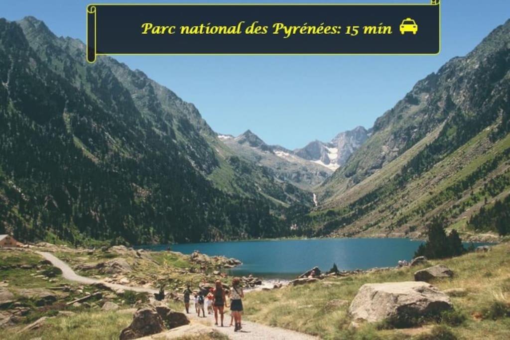 a group of people walking on a path near a lake at LE MEDITERRANEEN *T2 (40m²) *WIFI*PARKING PRIVE* in Lourdes