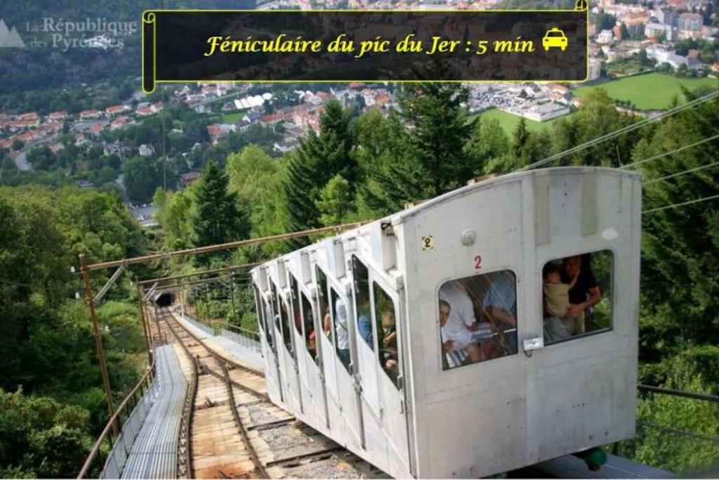 a cable car with people on it on a mountain at LE MEDITERRANEEN *T2 (40m²) *WIFI*PARKING PRIVE* in Lourdes