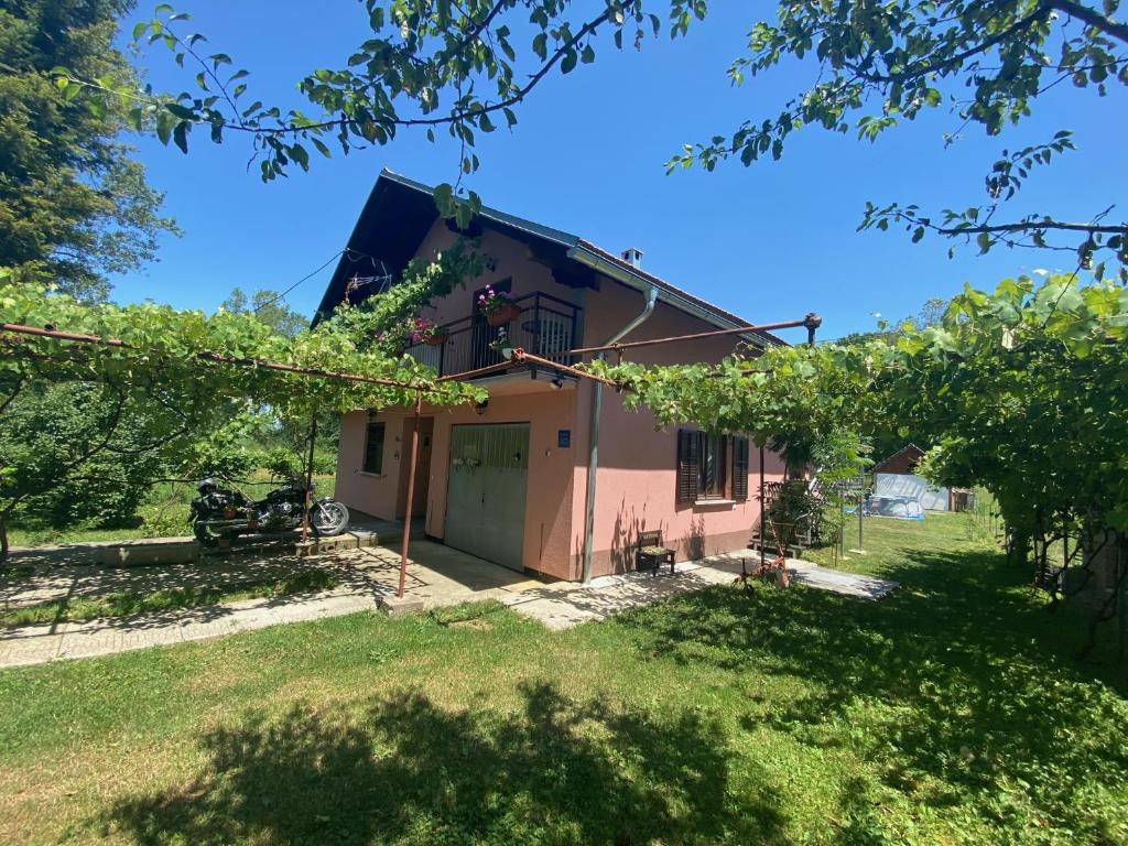 ein Haus mit grüner Tür und Hof in der Unterkunft LiamMarco in Plaški