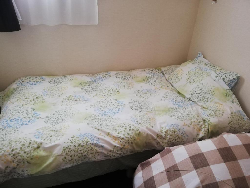 Postel nebo postele na pokoji v ubytování YUFUKANⅡ
