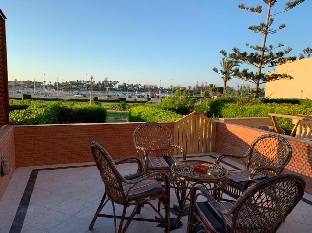 a patio with chairs and a table on a balcony at Marina 2 chalet lake front in El Alamein