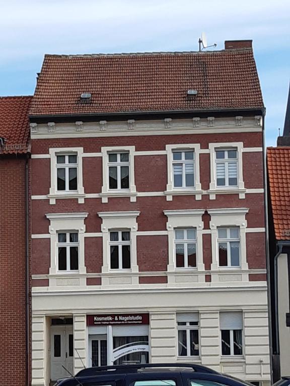 a large red brick building with white windows at FeWo Wüste Worth in Stendal